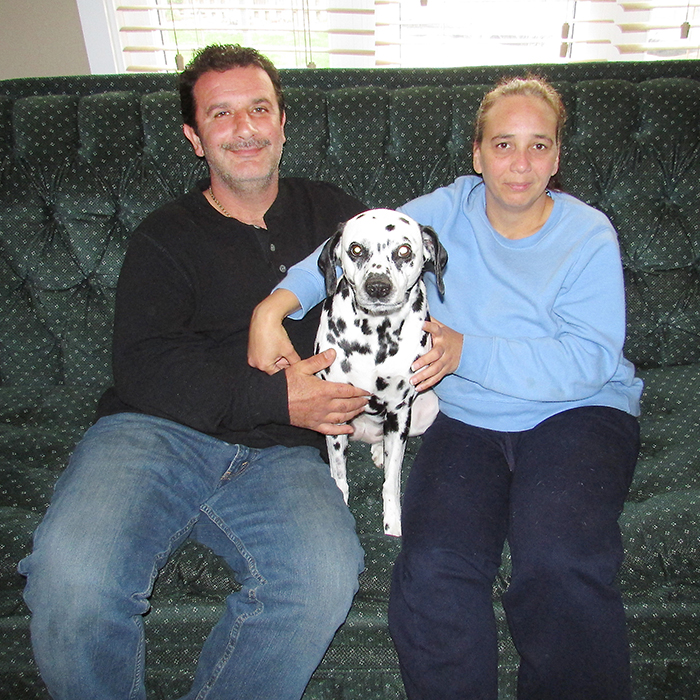 Joe and Jocelyn Milazzo sit with their “fur baby” Morla. Their Dalmatian is back to her happy self these days after being the first pooch in the province to undergo laser surgery to have glaucoma removed from her eye.