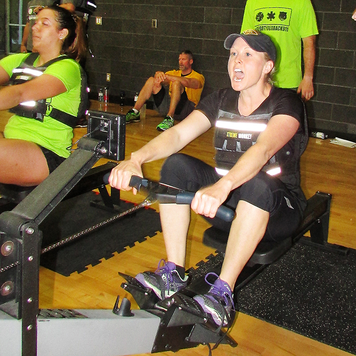 OPP Spec. Const. Maddie Luyt cheers on a teammate and waits for her turn to row at the Clash of the Sirens competition on Saturday at the St. Clair College Health Plex. The event, which pitted teams of police officers, firefighters, paramedics and students against one another in a series of fitness challenges, is a fundraiser for Chatham-Kent Victim Services and national service dogs.