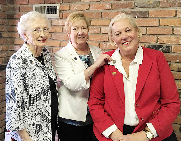 Pictured are past June Callwood award winners Kathleen Moderwell, left, and Lyn Rush presenting Jennifer Wilson with her June Callwood pin.
