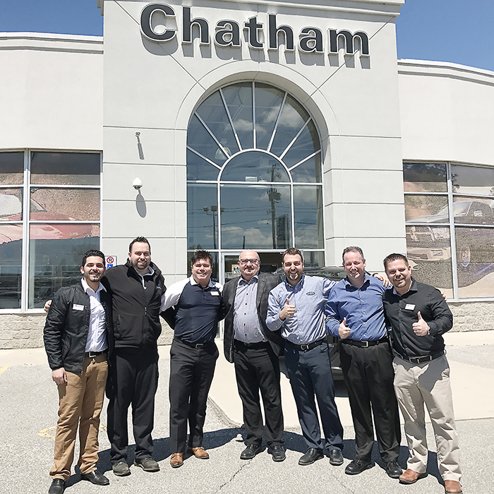 From left, KC Chaaban, Brian St. Pierre, Scott Bishop, Vince Lally, Adam Lally, Mike Hogue, and Matt Herder celebrate the recent sale of Chatham Chrysler to the Lally family.