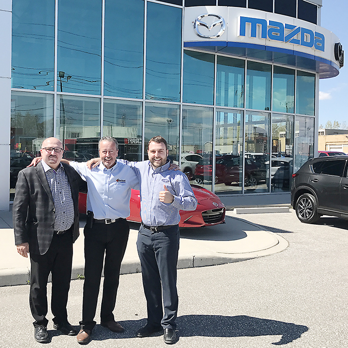 From left, Vince Lally, Dave Tessier and Adam Lally are all smiles after the Lallys recently took ownership of Chatham Mazda. Tessier will stay on as general manager.