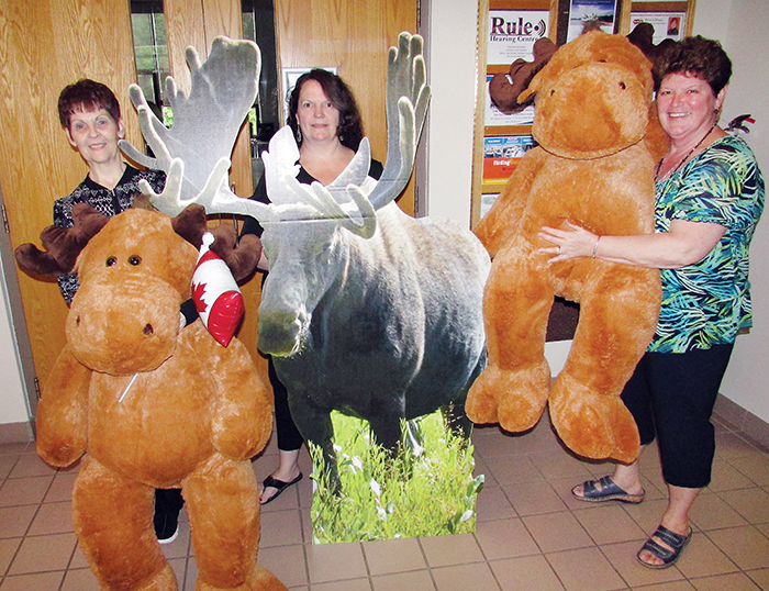 From left, Active Lifestyle Centre personnel Cheryl Sterling, Linda Lucas and Jan Reinhardus share a laugh and several iconic Canadian moose in advance of Canada 150 celebrations planned at the Merritt Avenue centre on June 30.