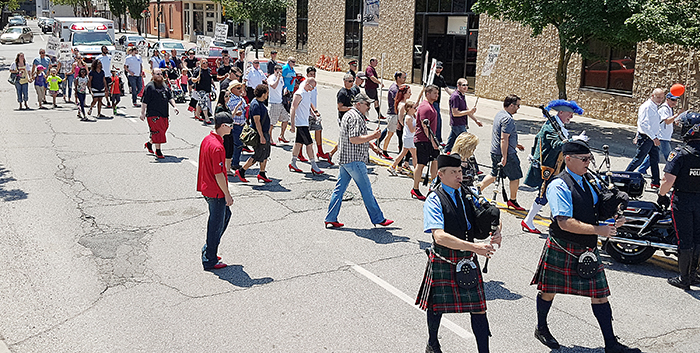 Walk a Mile in Her Shoes participants hobble out for their trek Saturday. The men raised about $20,000 for the Chatham-Kent Women’s Centre.