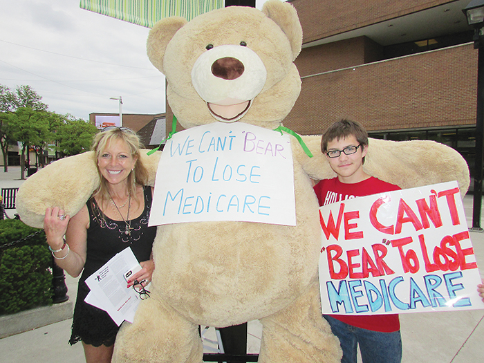 Simon Derochie, 13, of Merlin is a teen concerned with the future of Canada’s health-care system. He came out Friday to take part in the “We Can’t Bear to Lose Medicare” campaign that is currently touring the province. The large bear was in Chatham with the Ontario Community Health Coalition volunteers, including Kelly Jones, left, from Thamesville.