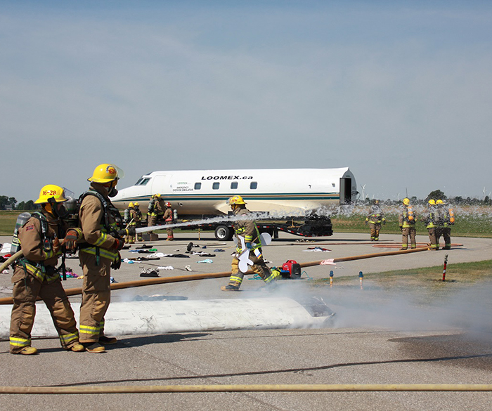 Chatham-Kent Firefighters sweat it out recently during a mock disaster at the municipal airport.