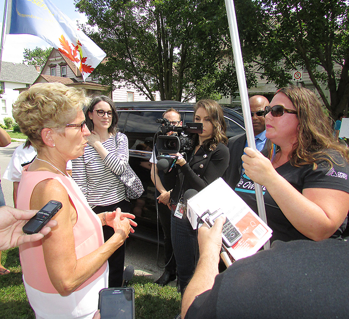 Ontario Premier Kathleen Wynne took a moment Thursday to talk to OPSEU area mobilizer Jordan McGrail about selling off provincial assets such as Hydro One during her afternoon stop in Chatham.