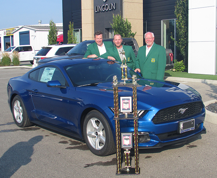 From left, 2016 Festival of Golf victors Dan Lundy, Joe Evers and Jim Lundy, showcase the 2017 Ford Mustang up for grabs at the second annual Festival Sept. 22, along with the outlandish trophy they took home for last year’s victory.
