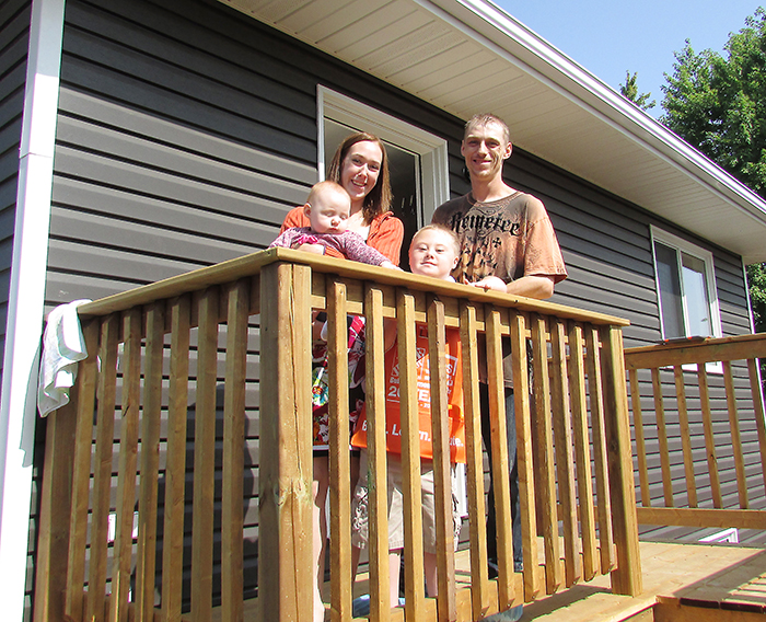 Nichole Spall and Lee Chrysler, with children Kylie and Lucas, are the proud owners of a new home in Blenheim thanks to Habitat for Humanity and a crew of volunteers.