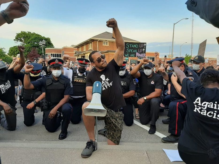 Hundreds march, flag lowered, police take knee for Black Lives ...